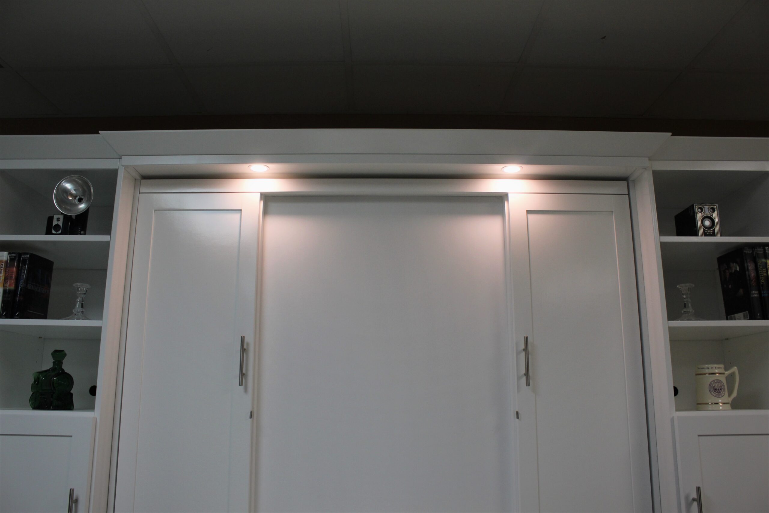 White Christy Murphy bed with hidden desk shown outset lights