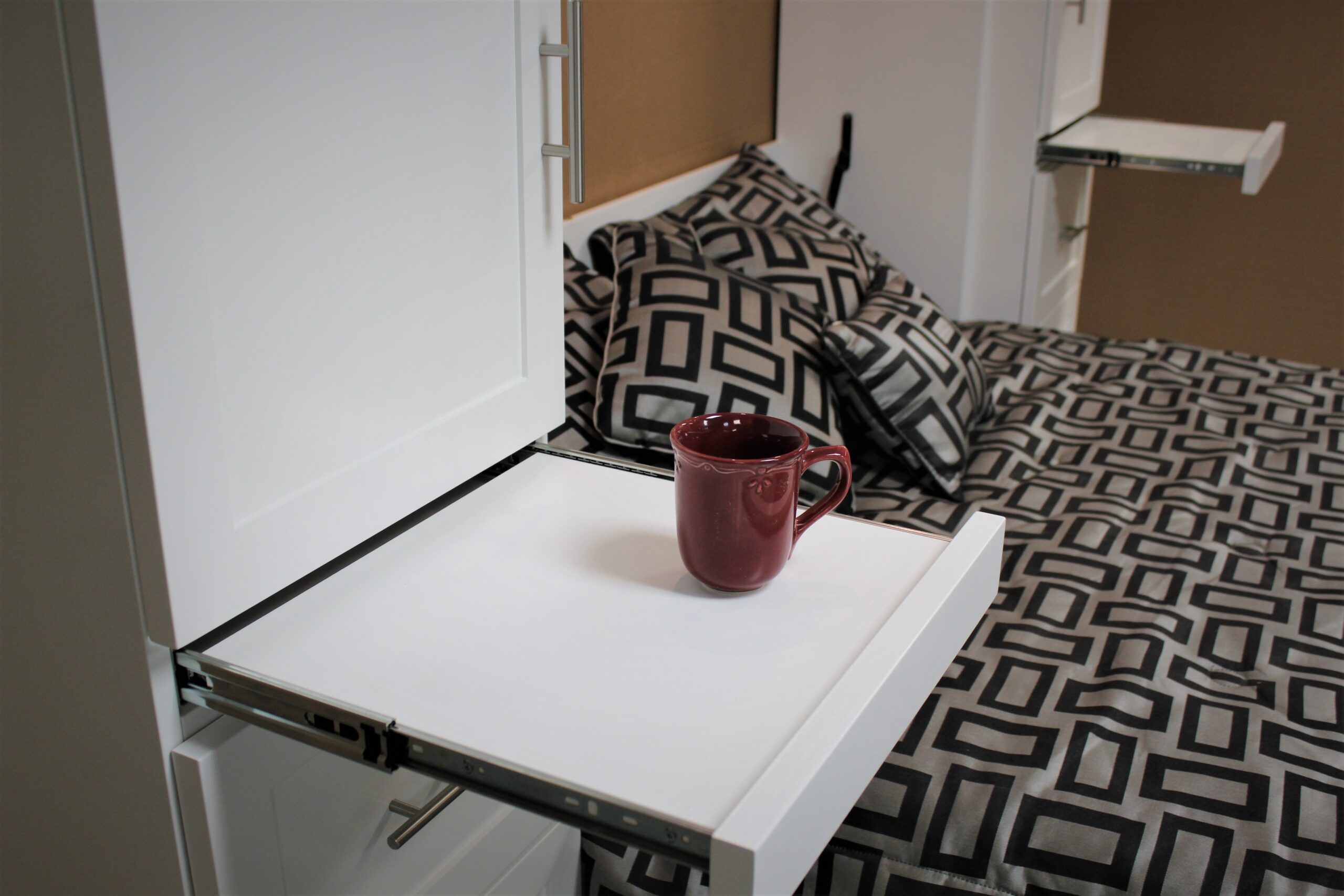 White Christy Murphy bed with hidden desk showing pullout tray